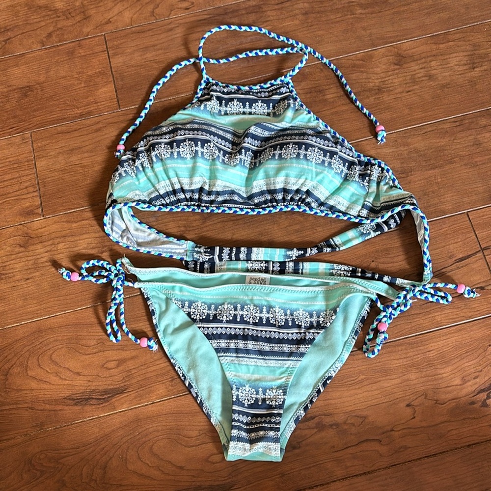Super cute bikini with lightly lined halter style top and tie side bottoms.
